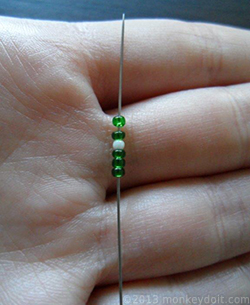 three beads B, one bead A and two beads B onto the needle