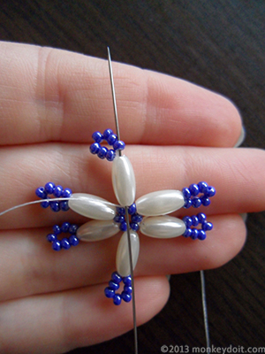 Go up through the next oval bead and one seed bead directly above it