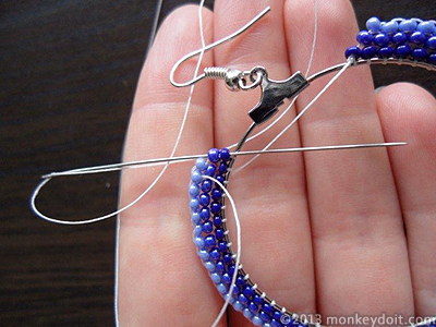 weave the thread back through the beads all the way to the frame of the earring