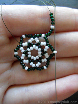 String four beads B, one A and four beads B and slide the needle through bead A from the row below