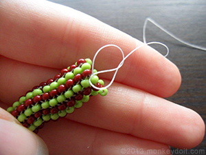 make a double knot at the base of the nearest bead
