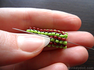 Push the needle up in between the beads a couple of rows from the one you were working on