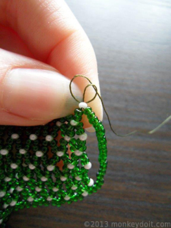 Tie a knot at the base of the bead