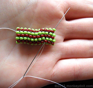 Bring the needle diagonally through the beads until it comes out where you left off