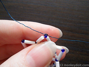 Tie the ends of the wire around the bead