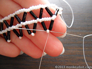 Slide the needle through the seed bead at the tip.