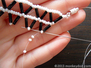 String 3 seed beads and make a loop by pushing the needle back through the same bead as in step 24.