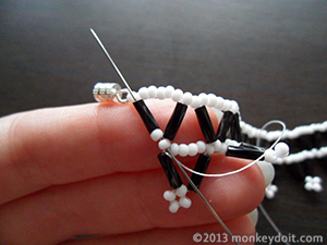 Weave the thread through several beads to bury the knot and cut the thread.