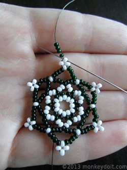 Make a loop by stringing 4 beads B and going back through bead A