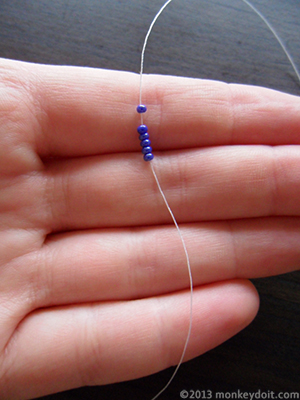Snowflake Beads: Slide 6 seed beads down to a few centimetres from the end of the thread