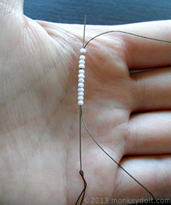Push the needle up through all the beads again starting from the first one