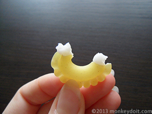 Apply a generous amount of paper adhesive onto the first piece of pasta