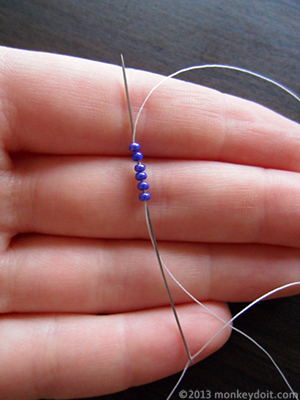 Snowflake beads: Push the needle back up through all the beads and pull to form a loop