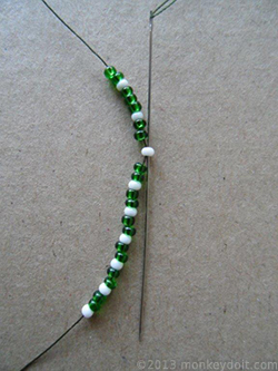 Push the needle down through the 10th bead from the top