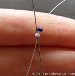 Needle back up through the first bead