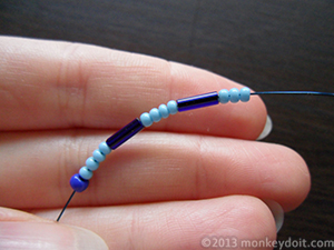 String the same sequence of beads in reverse with three small seed beads at the end instead of just one