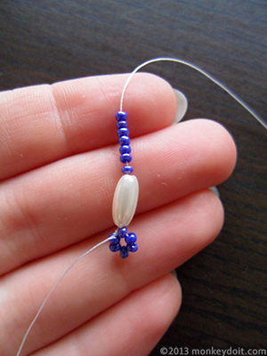 String one oval bead and 7 seed beads onto the thread