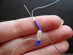 Slip the needle up through all the seed beads