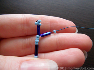 Slip one bugle bead and one small bead onto the wire