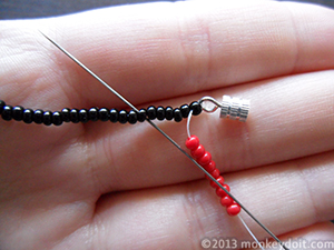 Slide 9 beads of a different colour (B) onto the thread, skip 5 beads underneath and push the needle through the 6th one.
