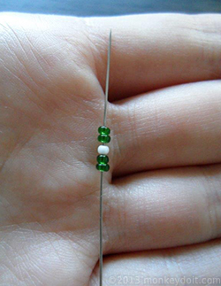 Slide 2 beads B, one bead A and 2 beads B onto the needle