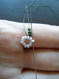 Skip one bead and push the needle through the next bead along