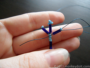 Wrap the wire around the ‘arm’ of the snowflake once and repeat steps 5-6 on the opposite side