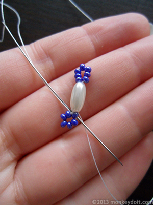 Move forward through the next seed bead from the central circle