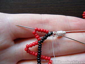 Bring the needle back through the last bead A and 5 beads B.