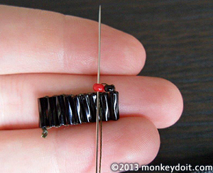 adding beads one by one to the earring