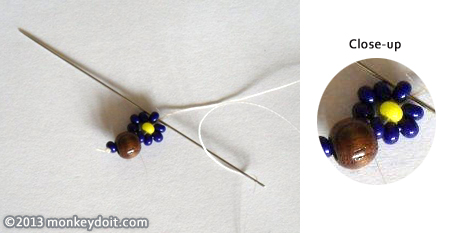 Slip one bead of a different colour onto the thread