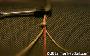 Clip looped hemp cords under the paper holder of a clip board