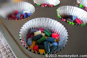 Crayons placed inside baking tray - cup cake pan