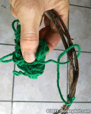 Looping the wool string around the vine
