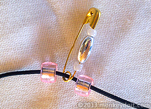 A closed safety pin with beads