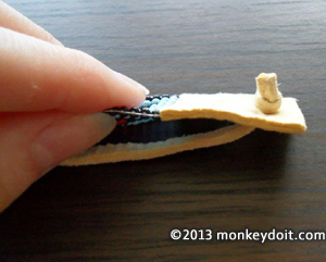 Leather strap through holes and secured with knot