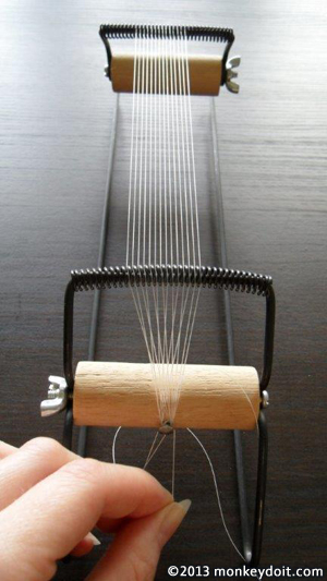 Tie the thread to the loom's dowel nail