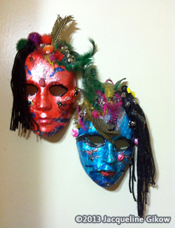 Mask making: Decorative masks adorned with feathers and string.