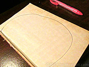 Showing a half moon shape drawn on the book for a pumpkin shape