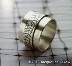 A silver roller-printed ring.